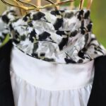 Fashion Exhibitions - A mannequin head with a black suit and a white scarf