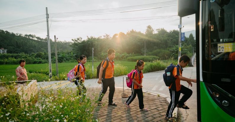 Boarding Schools - Group of Teenagers with Backpacks Boarding a School Bus