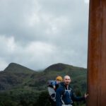 Snowdonia - Man Standing Beside a Giant Sword Near a Body of Water